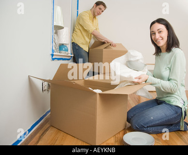 Couple unpacking boxes in new house Stock Photo