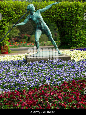 sculpture spewer in the middle of coloured flowers in Grugapark Essen Stock Photo