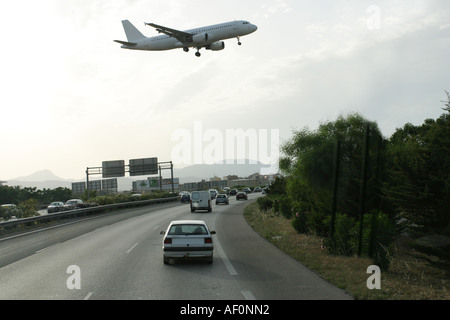 Driving down the highway near Palma Airport Mallorca Spain. A plane is passing over the traffic and is about to land. Stock Photo