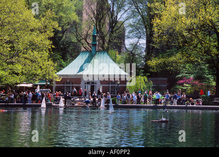 New York City Central Park Boat Pond The Conservatory Water. People in the park watching model toy sailboats. Kerbs Boathouse. Boat Basin. USA Stock Photo