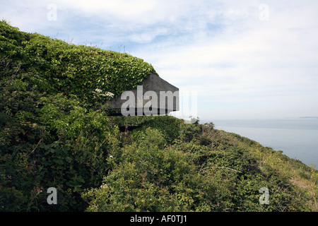 Second world war German military bunker built during the occupation by the nazis overlooking part of Guernseys coastline Stock Photo