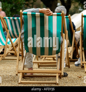 Deckchair relaxation. No model release required: back views, blur makes all unrecognizable Stock Photo