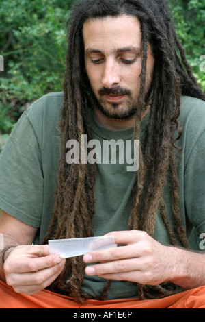 hippy preparing rolling and smoking marijuana joint photos series Stock Photo