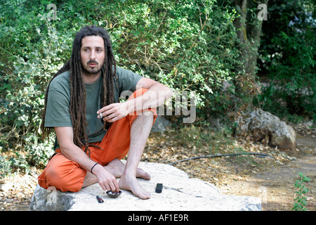 hippy preparing rolling and smoking marijuana joint photos series Stock Photo