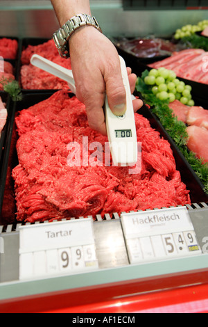 Food quality control Temperature measurement at a butcher s shop in a supermarket Stock Photo