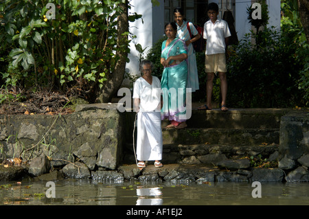 LOCAL LADY FISHING IN BACKWATERS OF NEDUMUDI, KUTTANAD, KERALA Stock Photo