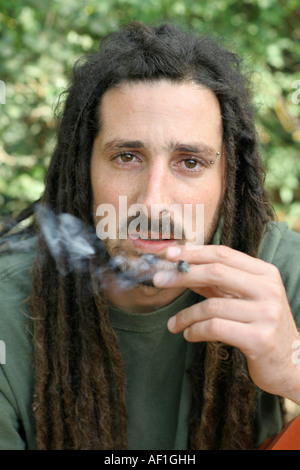 hippy preparing rolling and smoking marijuana joint photos series Stock Photo