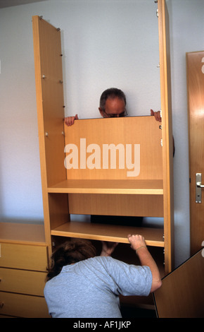 Couple assembling flat pack furniture at their home in Solingen, North Rhine-Westphalia, Germany. Stock Photo