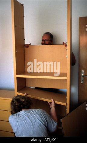 Couple assembling flat pack furniture at their home in Solingen, North Rhine-Westphalia, Germany. Stock Photo
