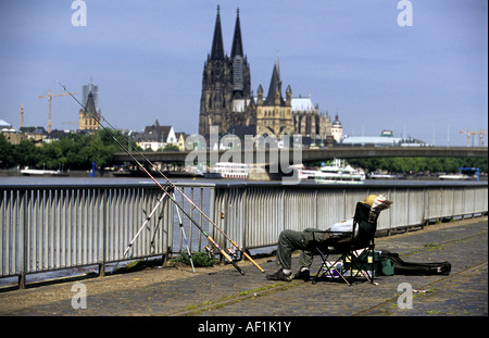 Angler fishing in the river Rhine, Cologne, North Rhine Westphalia, Germany. Stock Photo