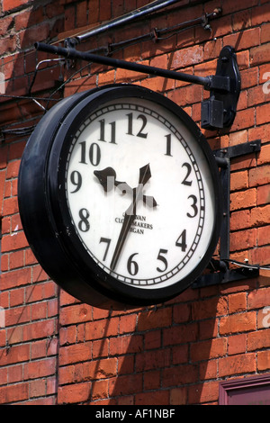 clock on red brick wall Stock Photo