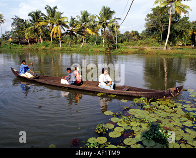 CROSSING THE BACKWATERS IN A COUNTRY BOAT KUTTANAD ALAPPUZHA Stock Photo