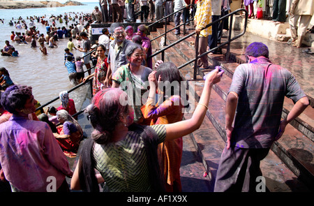 Indian families celebrating Holi Spring Festival at Gomati Bathing Ghat in Dwarka, Gujarat, India Stock Photo