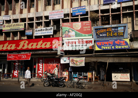 Advertising on Shop Fronts of buildings in Nasik, Maharashtra, India Stock Photo