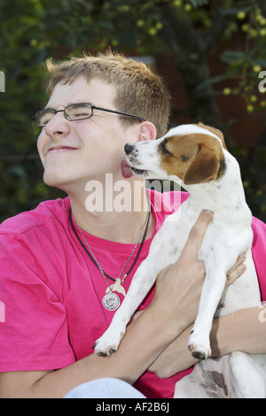 Jack Russell Terrier (Canis lupus f. familiaris), Boy with Jack Russel Terrier in his arm Stock Photo