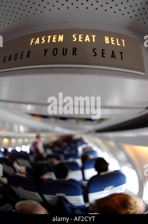 Fasten your seatbelt sign inside a passenger jet Stock Photo