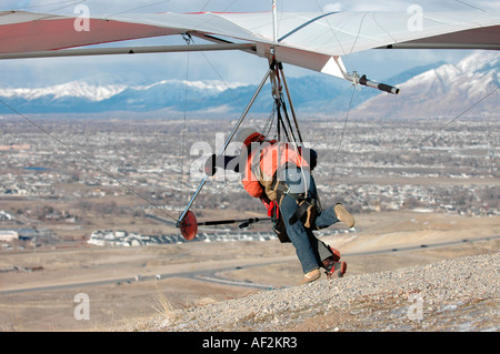 Hang gliding instructor and his student on take off to fly in tandem Stock Photo