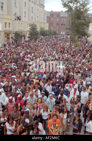 Large multicultural crowd of people in the streets of Notting hill at annual carnival time. Stock Photo