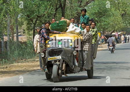 Indian auto rickshaw overloaded with sacks of rice on a country road ...