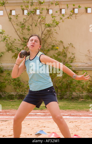 school girl throwing shot putt on school sports day Stock Photo