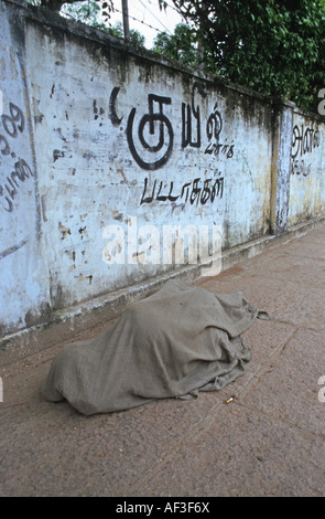 Homeless sleeping on sidewalk, India Stock Photo