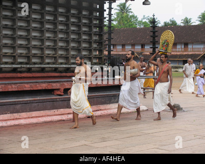 Holy people performing daily worship rituals in Shri Krisnha temple, Ambalpuram, Kerala, India Stock Photo