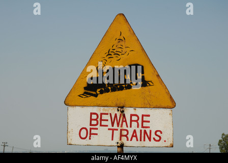 Sign warning of approaching trains at the side of the Kisumu Maseno road in Western Kenya East Africa Stock Photo