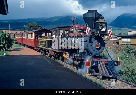 The old Lahaina to Kaanapali steam sugar cane train pulling red passenger carriages on a pleasure ride on Maui Island Hawaii Stock Photo