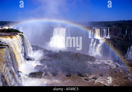 Rainbow formed in the rising spray of Iguassu waterfalls at the borders of Brazil and Argentina Stock Photo
