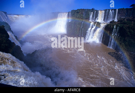 Semi circular rainbow formed in the rising spray of Iguassu waterfalls at the borders of Brazil and Argentina Stock Photo