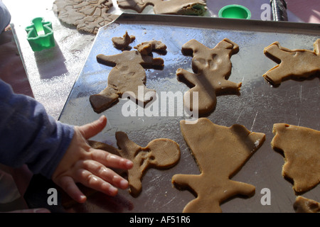 High angle view of a child's hand making cookies Stock Photo