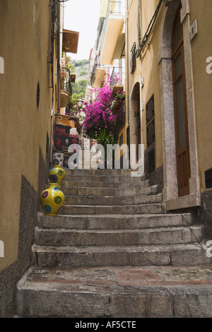 one of the many steep interconnecting stepped passageways between streets at different levels in Taormina Stock Photo
