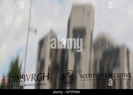 Scottish Parliament building reflected in the stainless steel signage outside of the entrance. Stock Photo