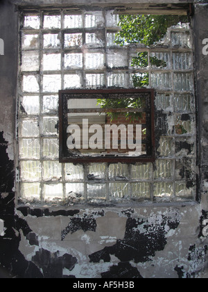 Broken Window in Glass Block Wall Stock Photo