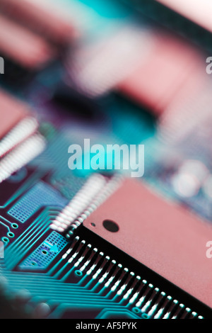Circuit board and microchip image in reds and blues Stock Photo