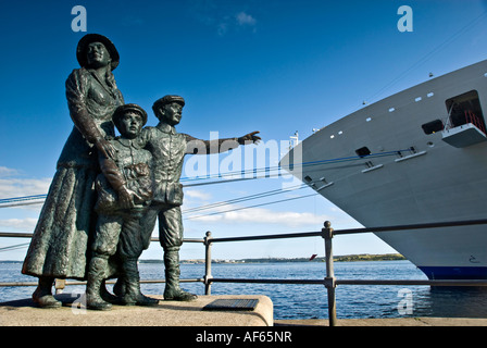 The statue of Annie Moore sculpted by Jeanne Rynhart at Cove  ( Cobh )  harbour in the Republic of Ireland. Stock Photo
