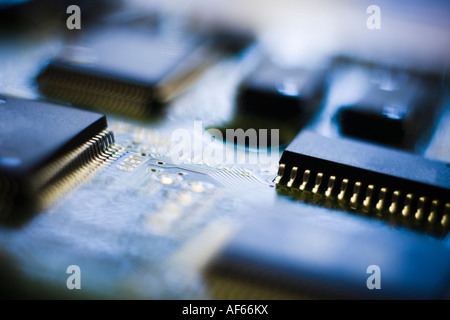 Circuit board and microchip image in reds and blues Stock Photo