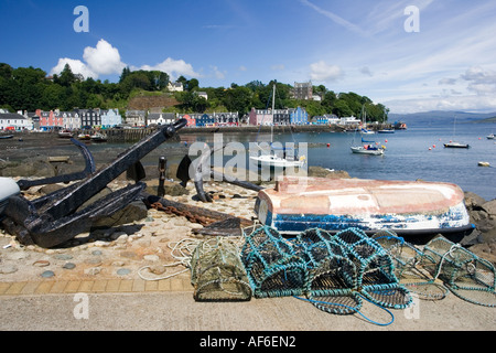Colourful houses along Tobermory harbour with old anchor in foreground and boats in harbour Isle of Mull Scotland UK Stock Photo