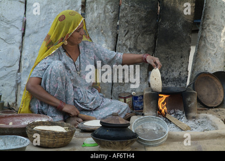 Bishnoi woman making chapattis in India Stock Photo