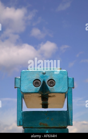 Coin operated beach binoculars against a bright blue cloudy sky Stock Photo