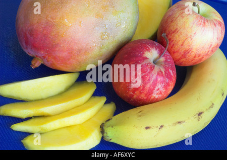 A fresh mango apples and banana which provide essential vitamins and fibre for good health Stock Photo