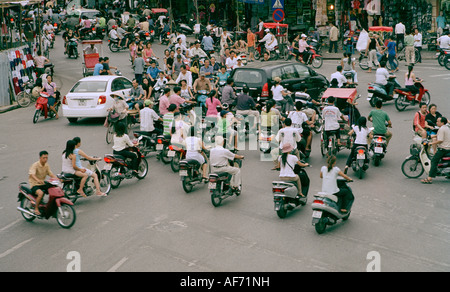 Road and street traffic in the Old City of Hanoi in Vietnam in Far East Southeast Asia. Modern Jam Congestion Scooter Vespa Car Transport Travel Stock Photo