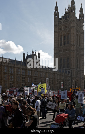 People outside Houses of Parliament with posters signs and banners on anti Iraq war protest demonstration march or rally by Stop Stock Photo