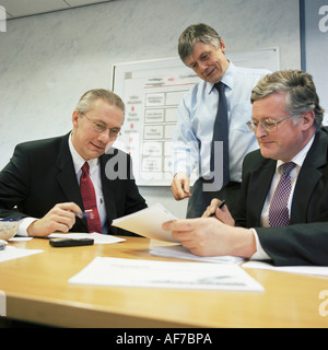 British industry. Three businessmen meeting in office. Stock Photo