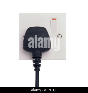A black plug in an electrical socket Stock Photo