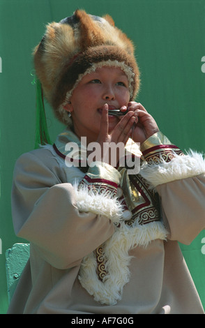 Portrait of a young girl playing national Altaic instrument komus. El-Oiyn - national festival of Altaic people. Russia Stock Photo