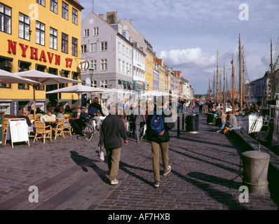 Strolling on Nyhavn waterfront, København (Copenhagen), Sjælland (Zealand), Denmark Stock Photo