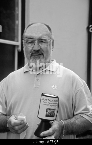 elderly man street collecting for Adur Talking Newspaper a charity for