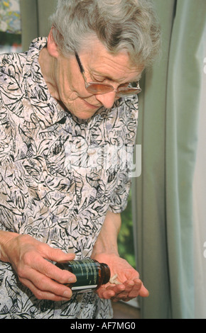 elderly woman taking tablets Stock Photo
