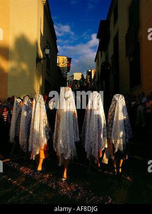 Ladies with mantillas, lace scarfs, traditional headcovering, procession on floral carpets, old town of La Orotava, Tenerife, Ca Stock Photo